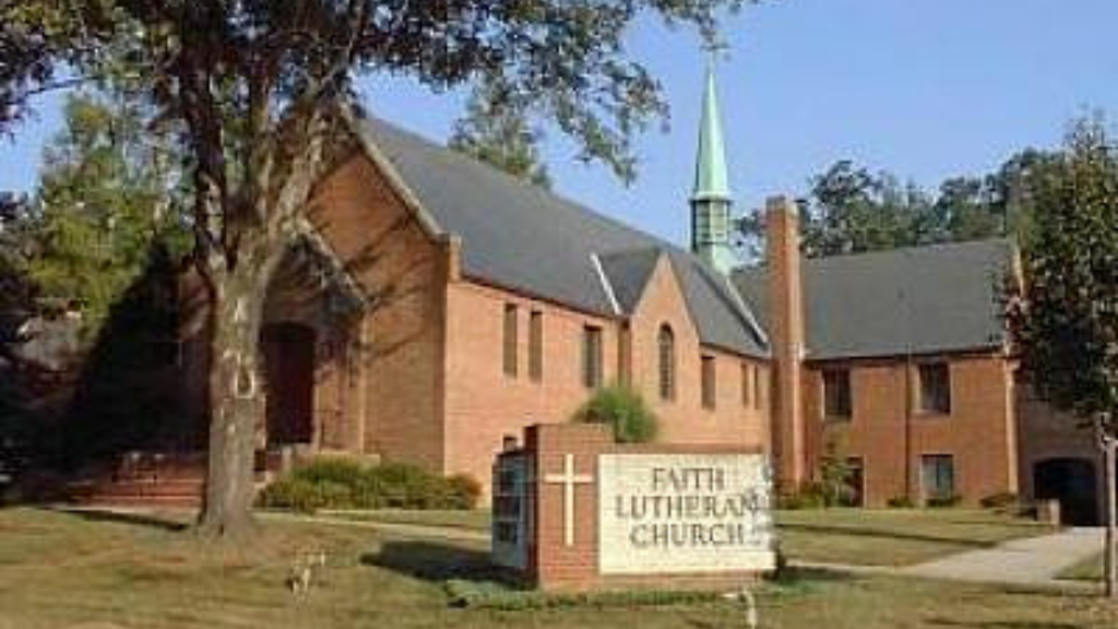 A brick church with a steeple. Sign in front reads "Faith Lutheran Church"