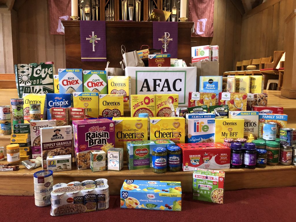 A pile of boxed goods with a sign that reads AFAC