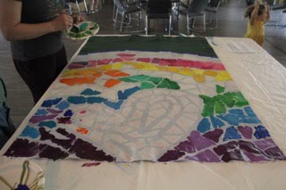A partially painted banner with rainbow colors